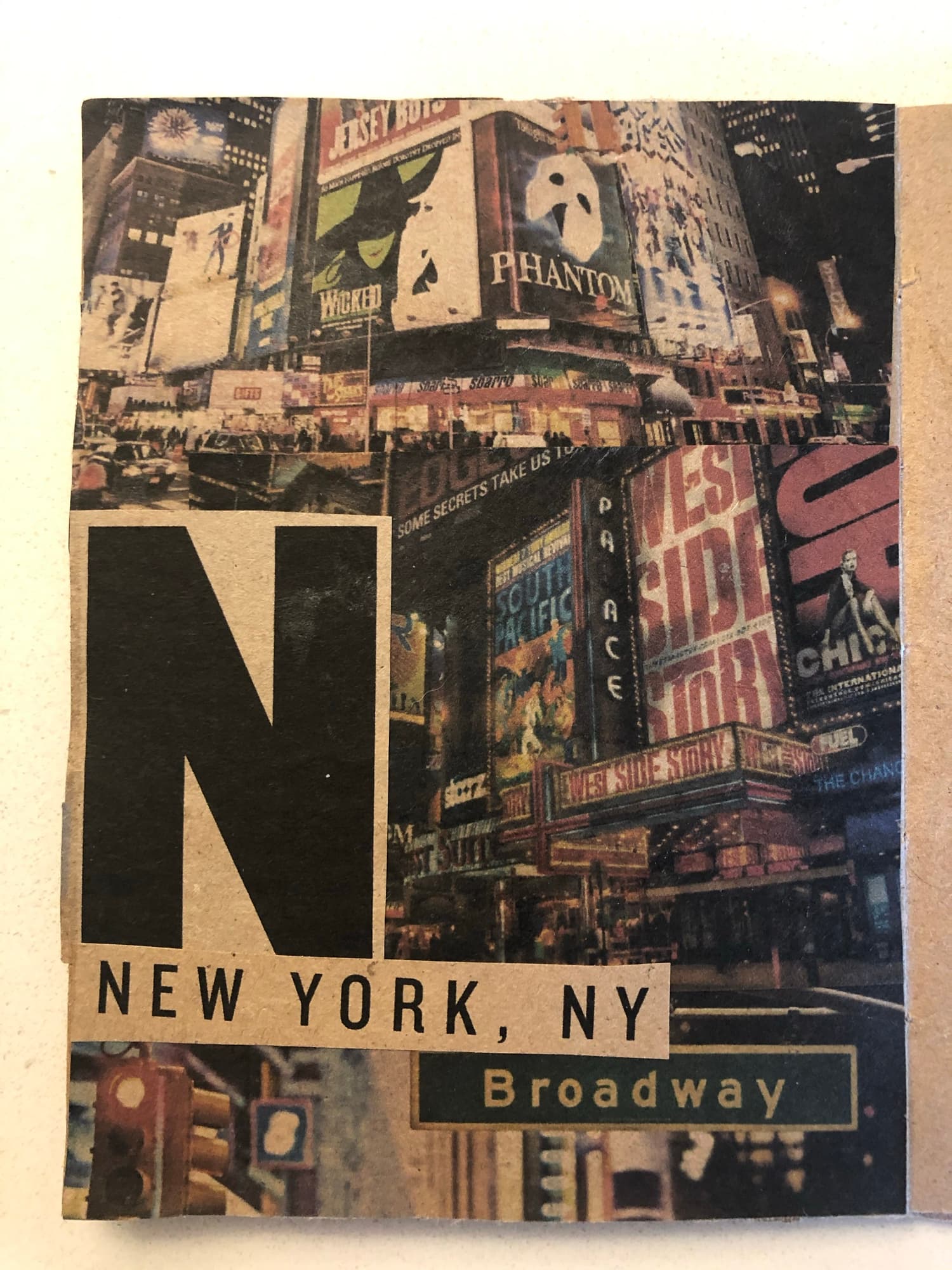 N spread: a Times Square photograph crowded with theater marquees framed by a black N, with NEW YORK NY · Broadway labeled along the right