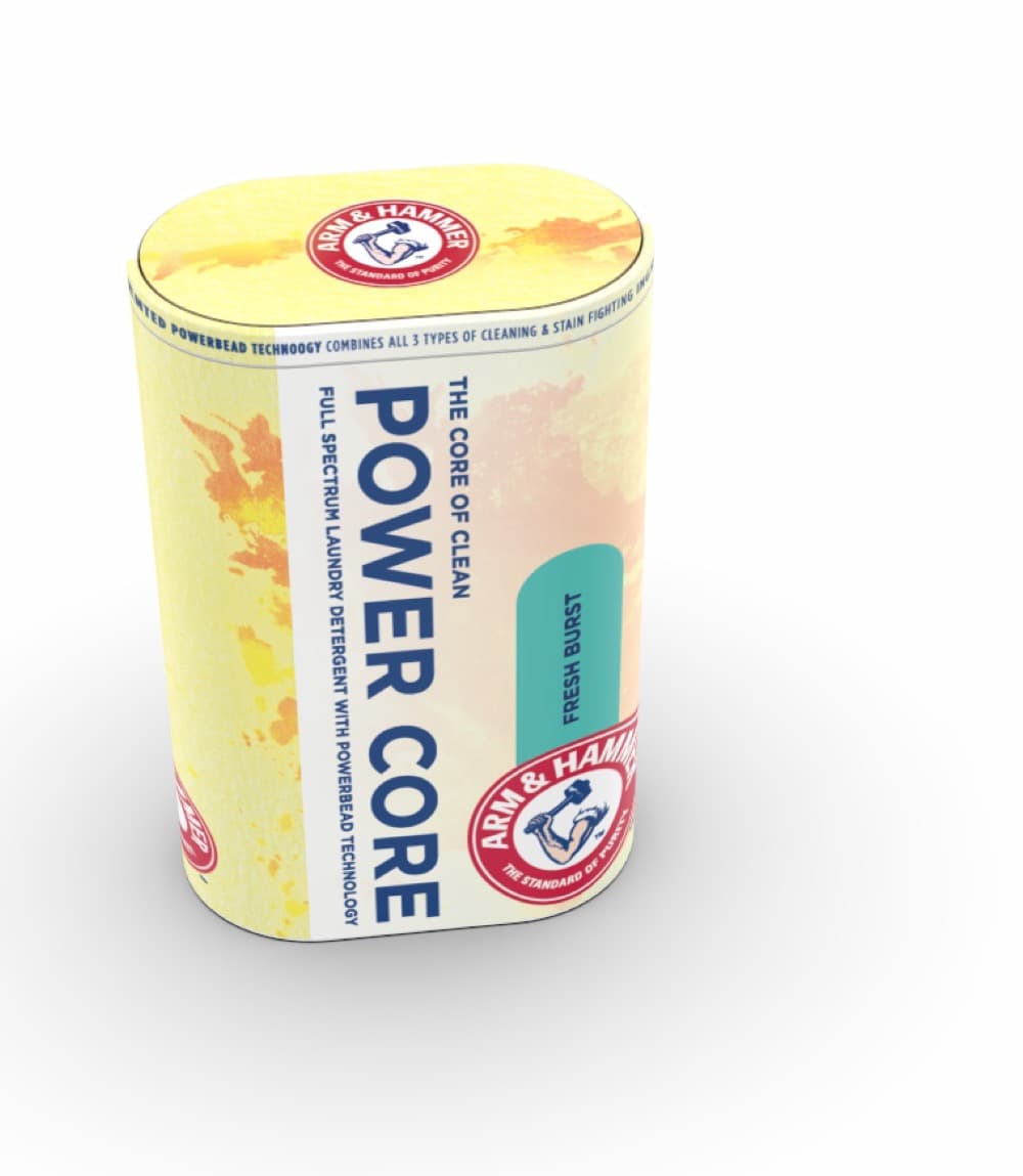 POWER CORE Fresh Burst, three-quarter view: yellow watercolor sleeve with the Arm & Hammer mark on the lid, teal variant pill catching the eye on the body