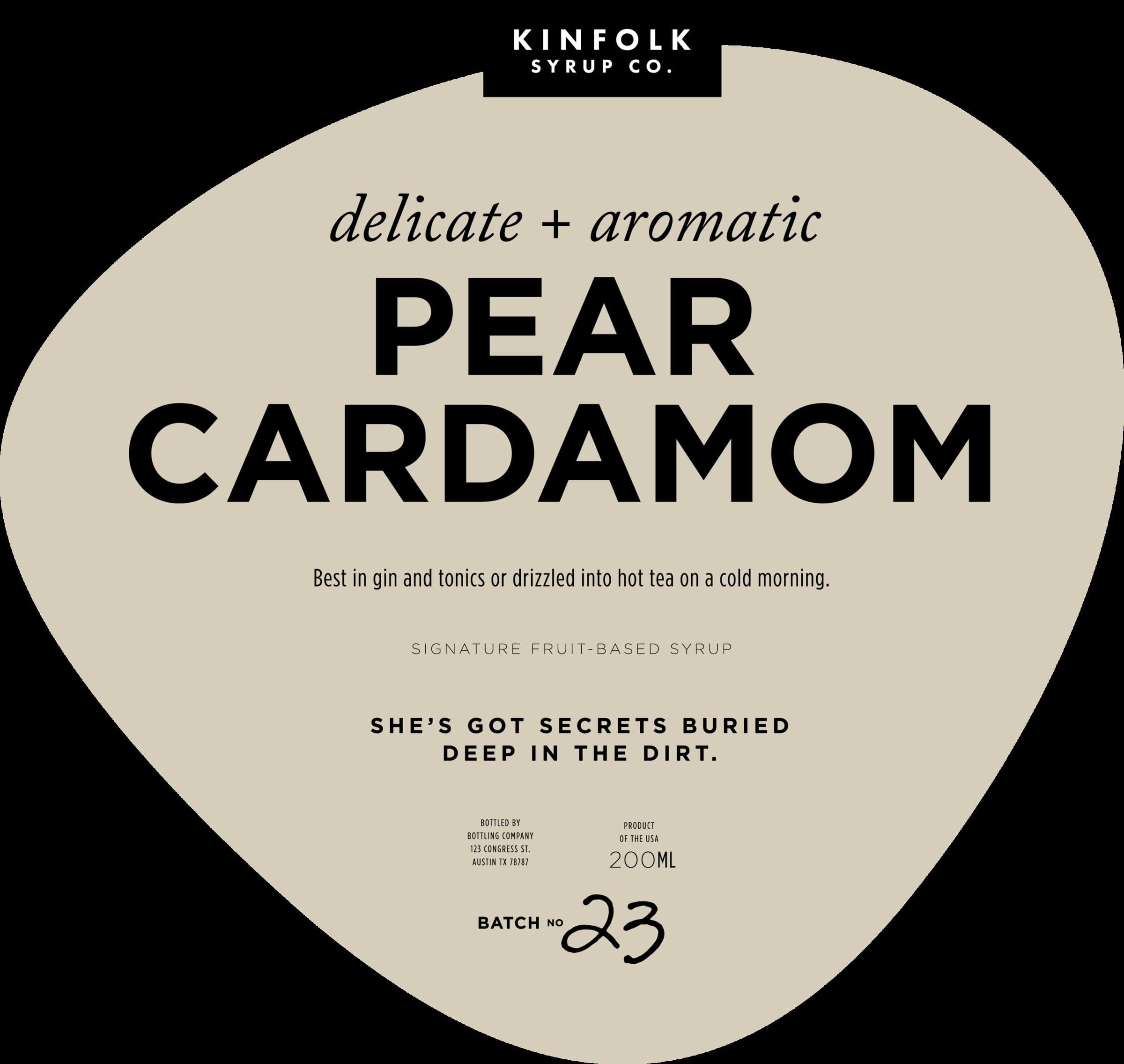 The Pear Cardamom label: bone-cream teardrop, 'delicate + aromatic' italic kicker, PEAR CARDAMOM in chunky black display caps, 'Best in gin and tonics or drizzled into hot tea on a cold morning,' and 'She's got secrets buried deep in the dirt' as the personality line.