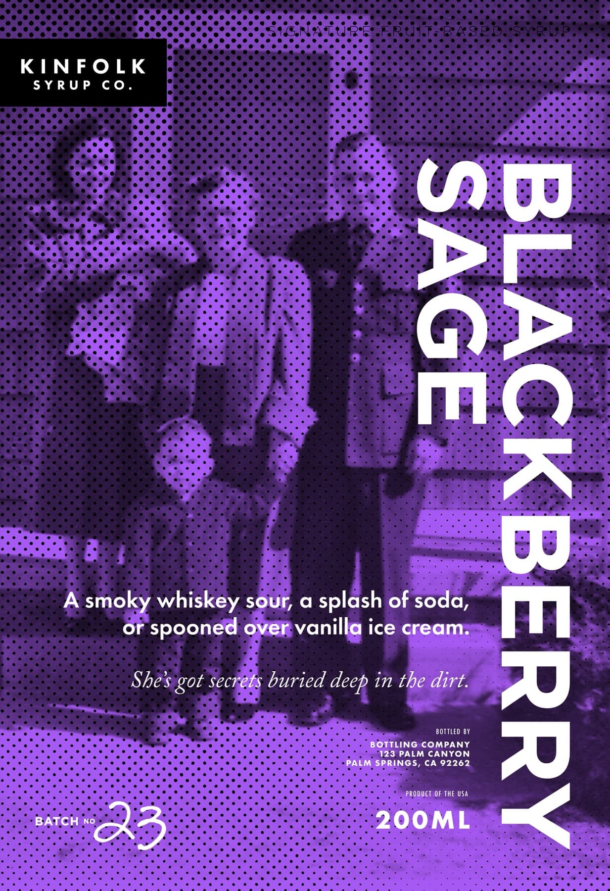 The original Blackberry Sage poster: a vintage family photograph of a family standing together with a small child, halftoned and washed in deep purple, BLACKBERRY SAGE set in tall white display caps down the right edge, the serving line 'A smoky whiskey sour, a splash of soda, or spooned over vanilla ice cream' and the personality line 'She's got secrets buried deep in the dirt' below, BATCH NO 23 in handwritten script at the foot.