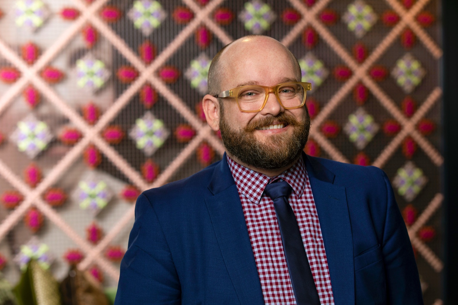 John Howrey, photographed at SCAD Savannah, Ruskin Hall, in front of a quilt-pattern backdrop