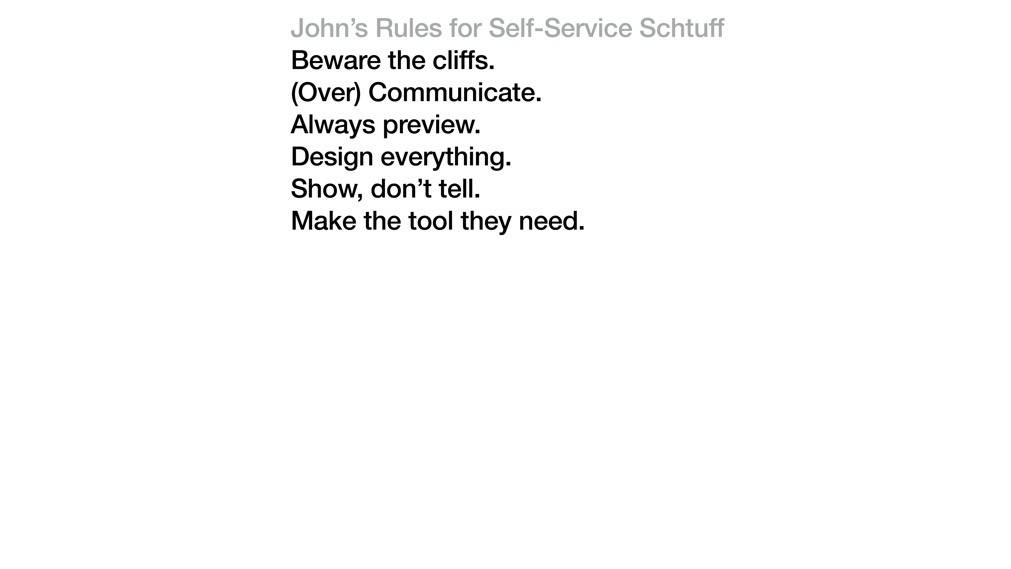 A presentation slide titled 'John's Rules for Self-Service Schtuff' in light gray. Below, in bold black sans-serif, six rules: Beware the cliffs. (Over) Communicate. Always preview. Design everything. Show, don't tell. Make the tool they need.